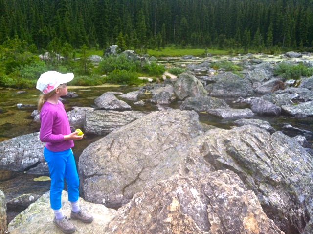 Girl standing on rocks in a stream