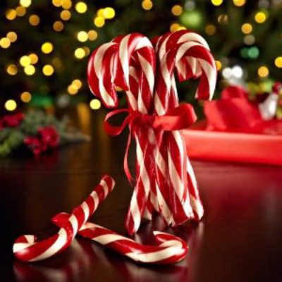 candy canes in front of a christmas tree