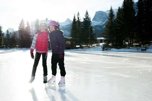 two girls on outdoor ice rink
