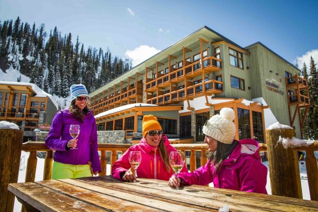 women drinking white wine at outdoor patio in winter