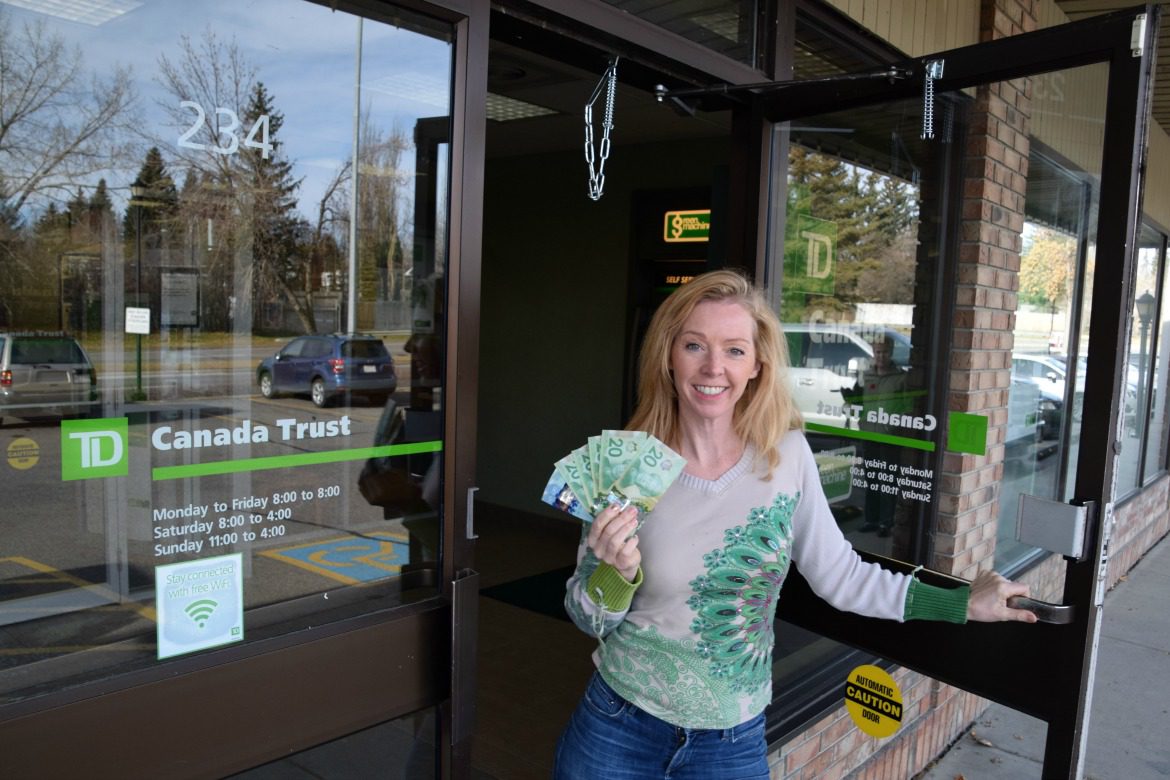 Woman leaving bank with cash