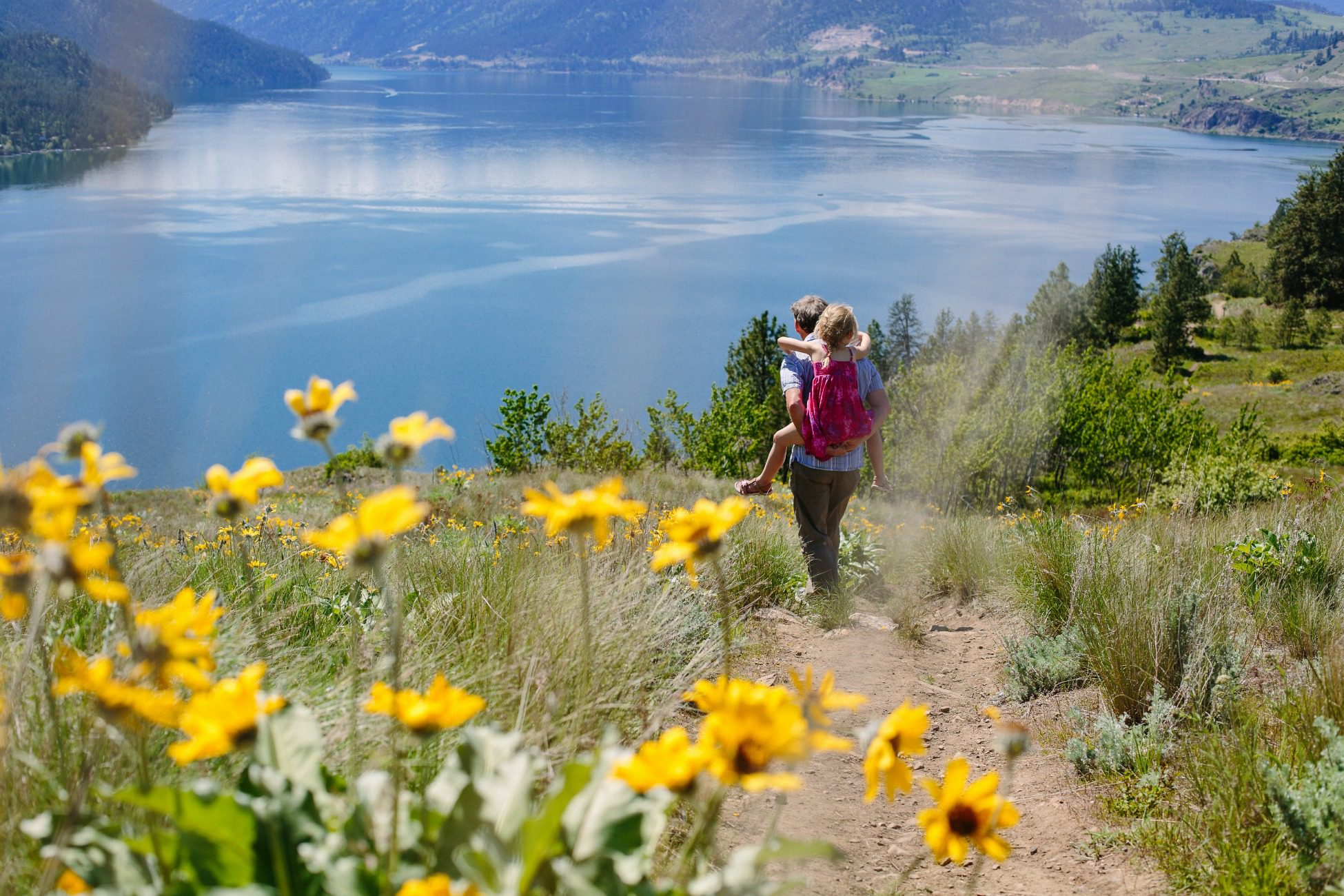 family hiking around shores of lake