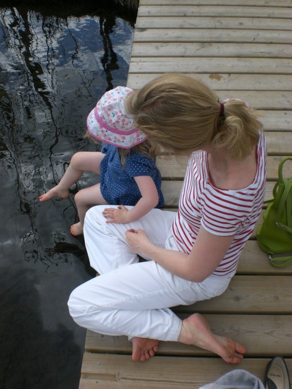 mom and daughter on a dock