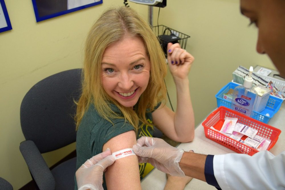 woman getting bandaid after shot
