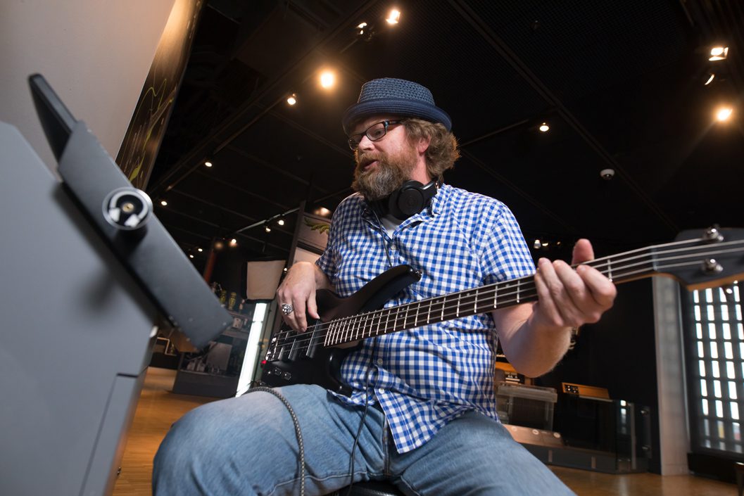 man playing guitar at museum