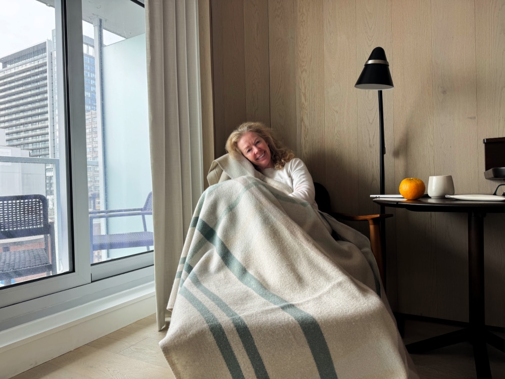 woman cozy with plaid blanket